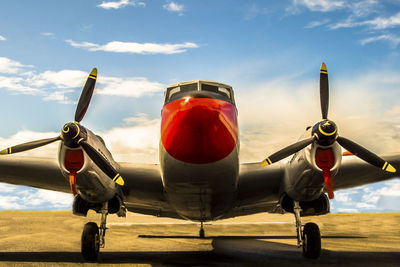 Airplane on runway against sky