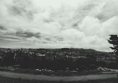 Cityscape against cloudy sky