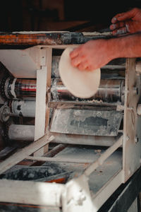 Cropped hand of man working at workshop