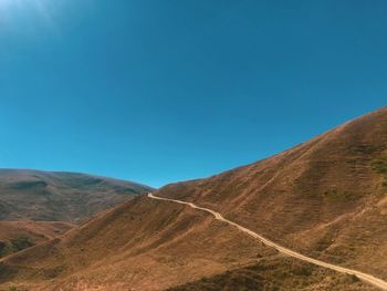 Scenic view of mountains against clear blue sky