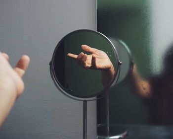 Reflection of hand on mirror