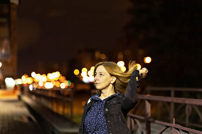 Portrait of a young woman in a night city on a summer evening. city lights.