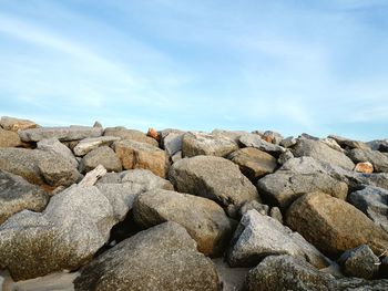 Rocks on beach against sky