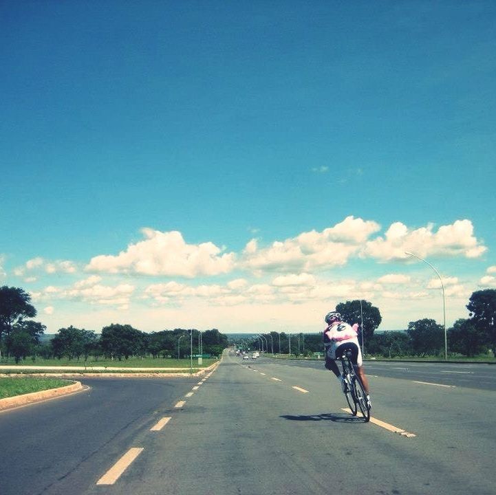 transportation, road, land vehicle, mode of transport, full length, riding, bicycle, street, rear view, lifestyles, sky, men, cycling, leisure activity, the way forward, on the move, road marking, car