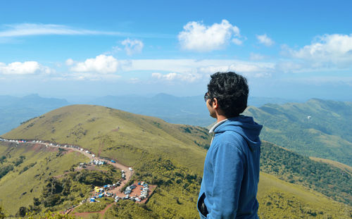 Man standing on mountain against sky