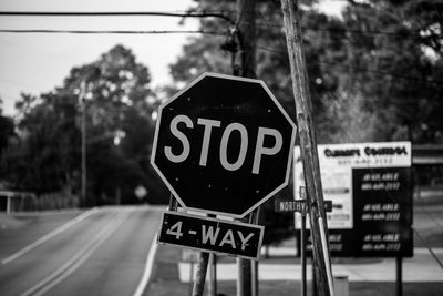 Close-up of road sign against trees