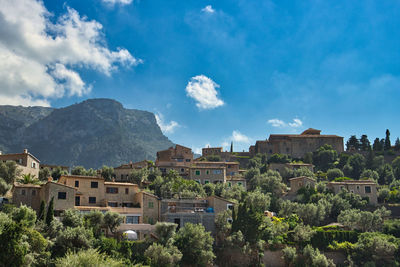 Panoramic view of buildings and mountains against sky