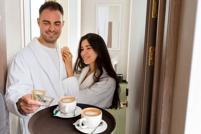 Room service serving coffee to customer