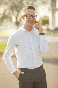 Portrait of smiling young man standing outdoors