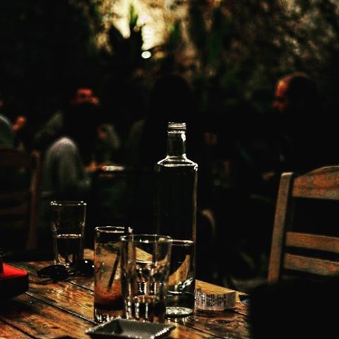 table, food and drink, drink, indoors, focus on foreground, refreshment, drinking glass, still life, restaurant, glass - material, wineglass, chair, wood - material, bottle, close-up, alcohol, empty, selective focus, freshness, absence