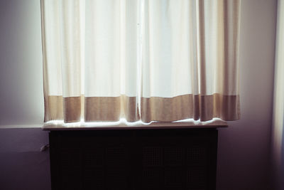 White curtain hanging on window at home