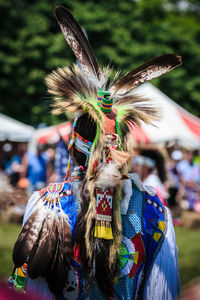 Rear view of man wearing headdress at event