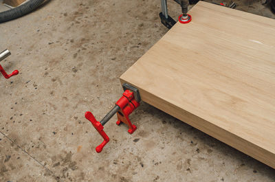 Wooden board in carpentry workshop. joiner's clamp. wood shavings, sawdust