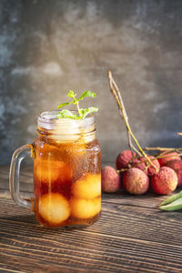 Close-up of fruits in glass jar on table