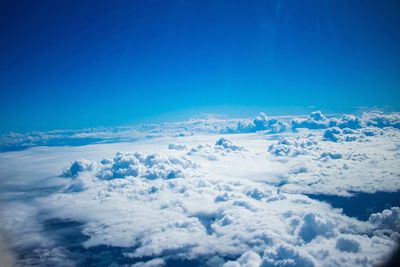 Aerial view of cloudscape against clear blue sky
