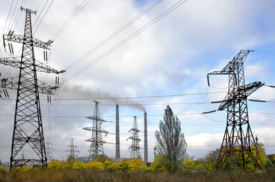 Low angle view of electricity pylon against sky