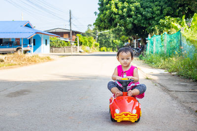 Cute girl sitting on road