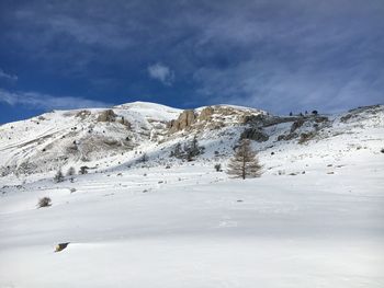 Scenic view of snowcapped mountains against sky