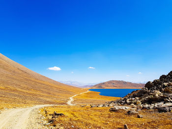 Scenic view of landscape against blue sky