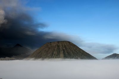 Scenic view of snowcapped mountain against cloudy sky