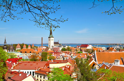 High angle view of townscape by sea against sky