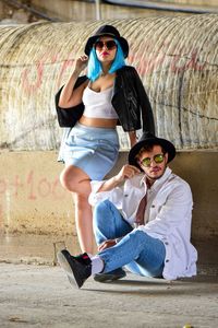 Young couple sitting on wall