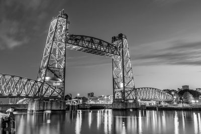 View of bridge over river against cloudy sky