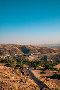 Aerial view of landscape against clear blue sky