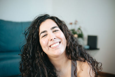 Close-up portrait of young woman at home