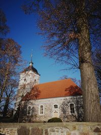 Low angle view of historic building against clear blue sky