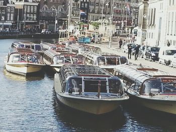 Boats in river with city in background