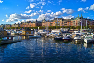 Boats in harbor with buildings in background