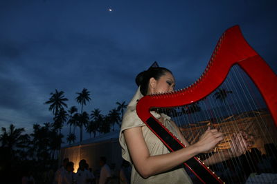 Midsection of woman against moon at night
