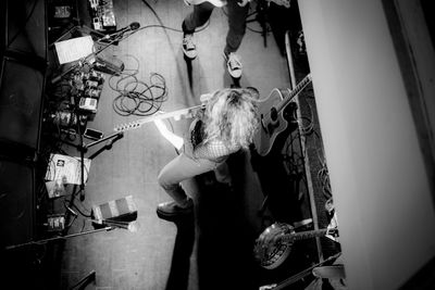 Directly above shot of woman playing guitar on stage