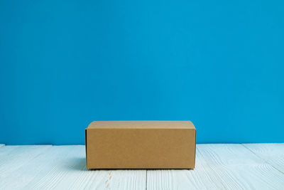 High angle view of box on table against blue background