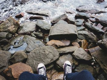 Low section of person standing on rock