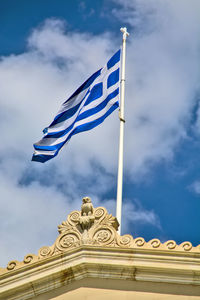 Low angle view of flag against blue sky