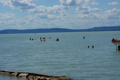 People on sea against sky