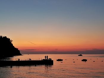 Scenic view of sea against orange sky