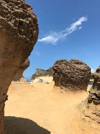 Rock formations in desert against blue sky