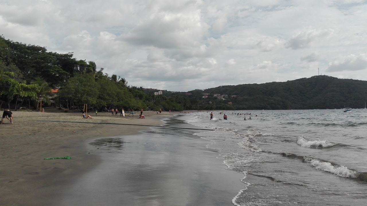 PEOPLE ON BEACH AGAINST SKY