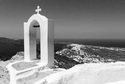 Cross by sea against sky