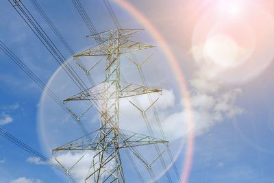 Low angle view of electricity pylon against sky