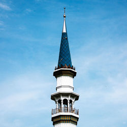 Low angle view of lighthouse on building against sky