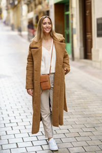 Portrait of woman standing in city