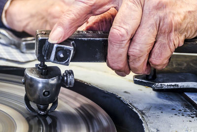 Midsection of man working on machine