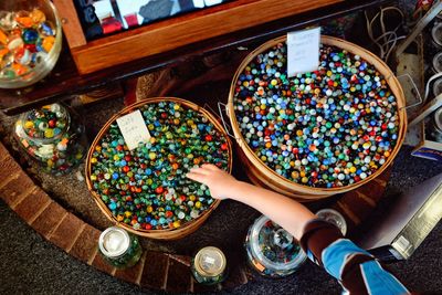 Cropped hand picking up colorful marbles