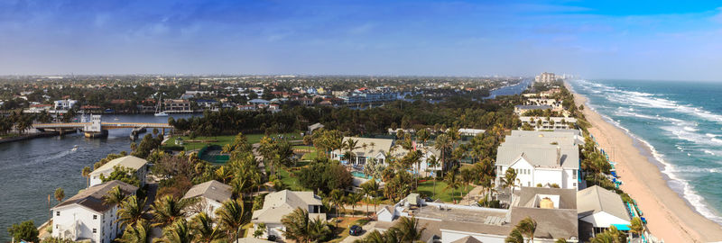 High angle view of buildings and sea against sky