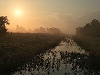 Scenic view of field against sky during sunset