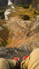 Low section of man standing in water